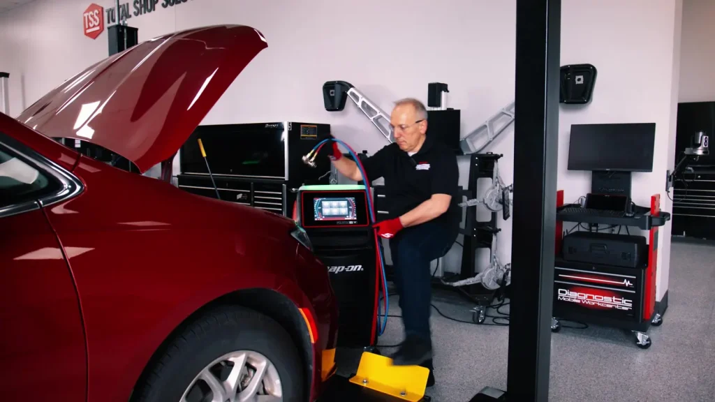 Snap-on technician connecting PolarTek R-1234yf service hoses to a vehicle